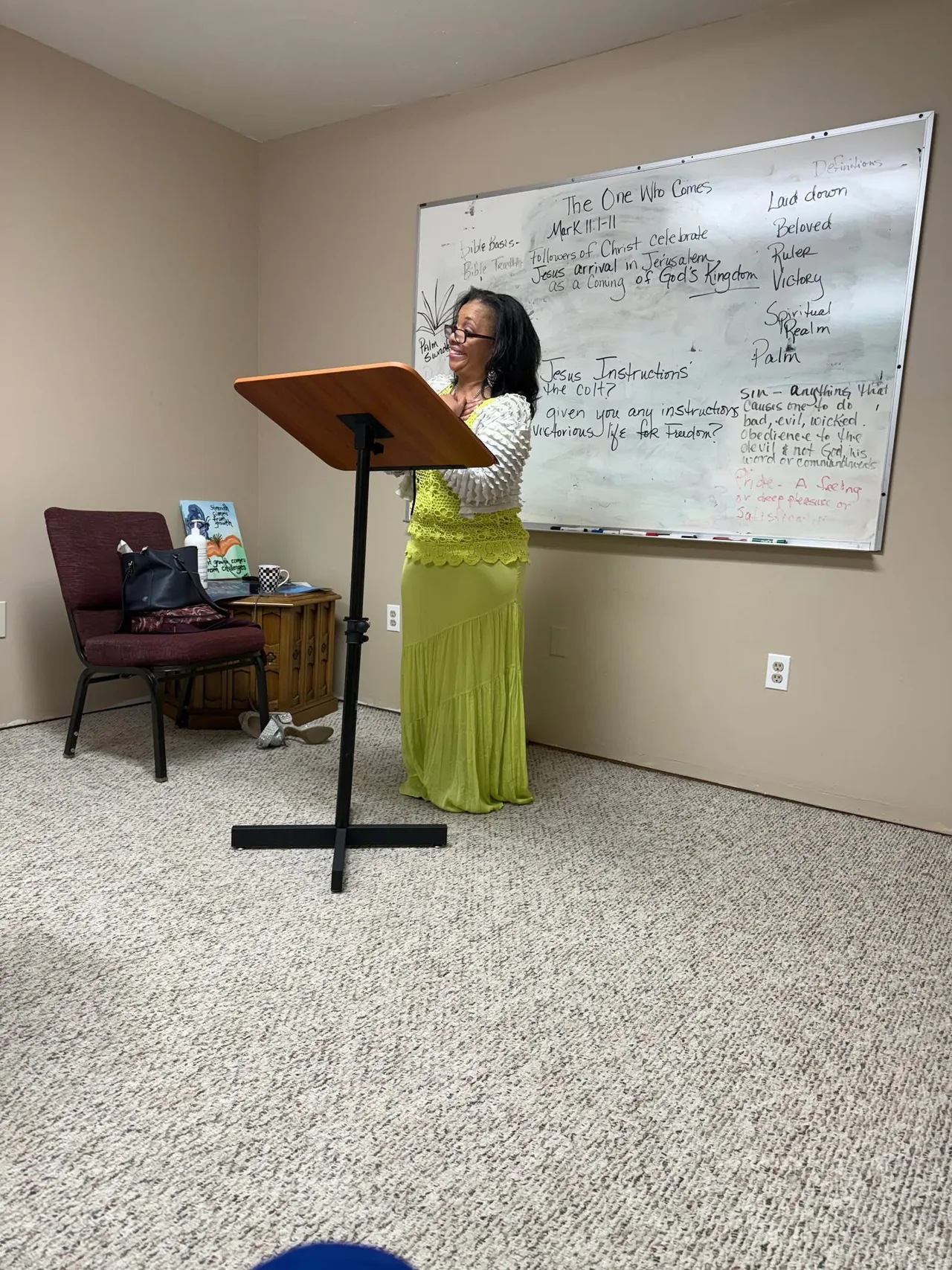 Monique Foster speaking at a lectern during a community program